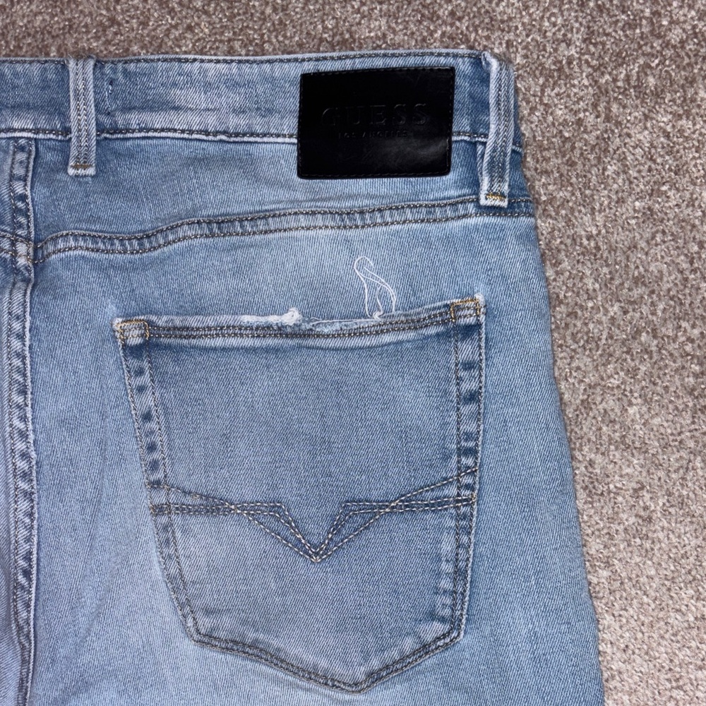 Guess Men's Slim Tapered Distressed Jeans in Faded Blue Wash - Picture 9 of 9